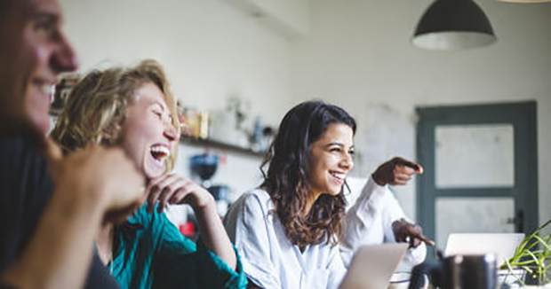 A group of people in an office laughing